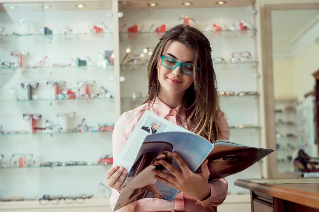 happy-see-words-clearly-without-blur-indoor-portrait-satisfied-attractive-european-woman-sitting-optician-store-while-reading-magazine-glasses-waiting-het-turn-check-sight.webp